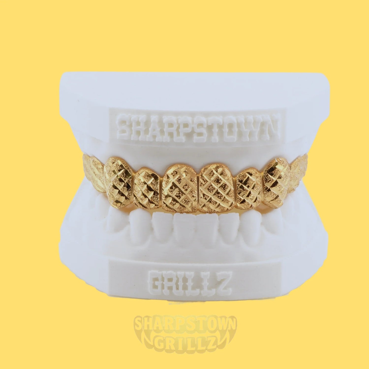 Custom 10K Gold diamond cut top teeth caps with diamond dust textured faces.