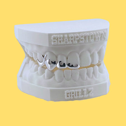 Handcrafted custom flame wireframe teeth caps showing smooth contoured edges.