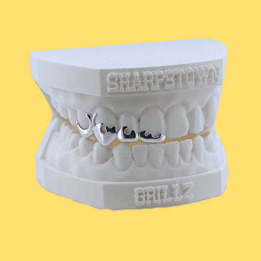Handcrafted custom flame wireframe teeth caps showing smooth contoured edges.