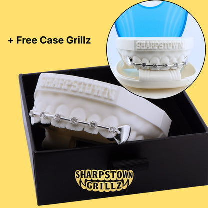 Silver braces bar style grillz with iced stone accents fitted on upper jaw teeth impression.