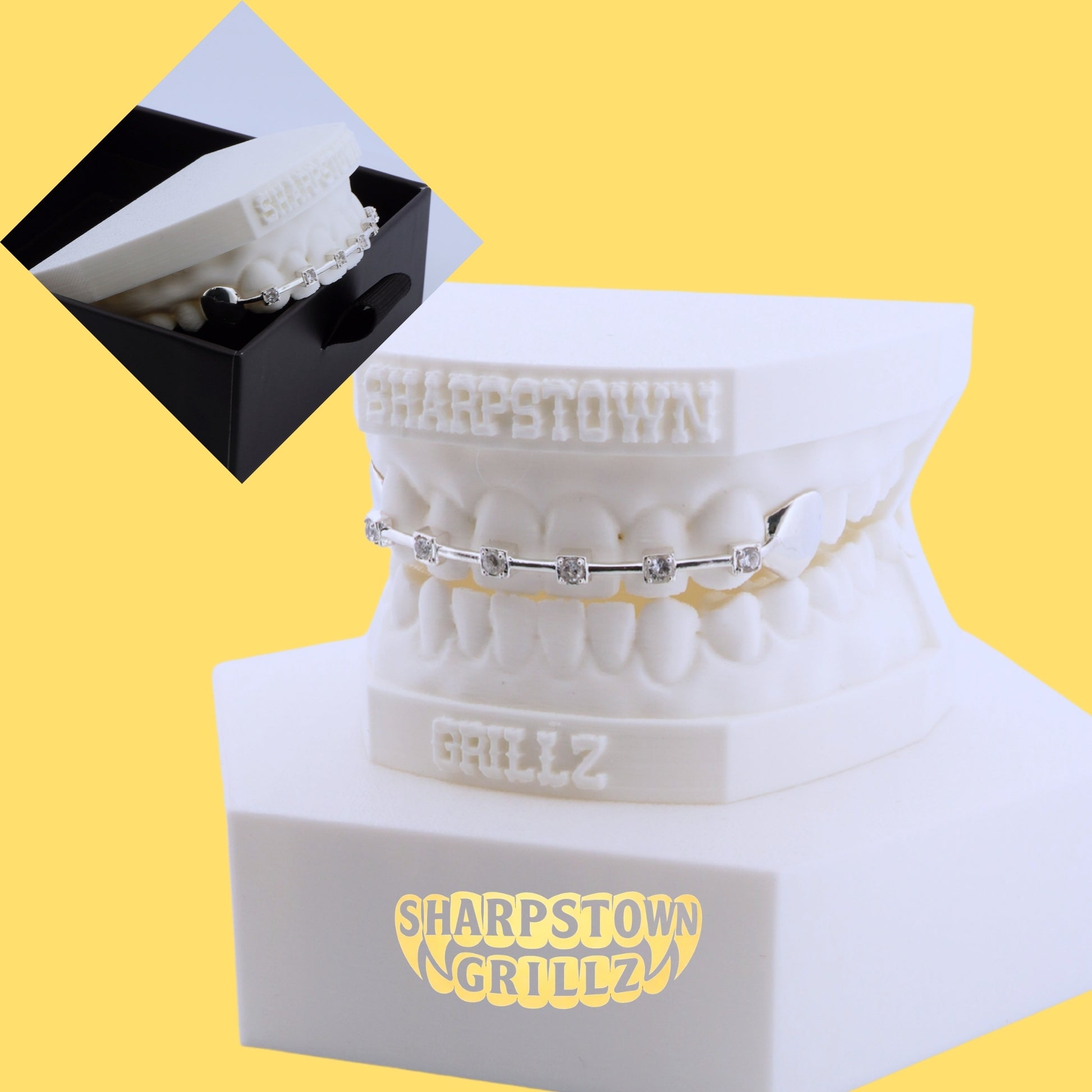 Custom 925 silver tooth bar with cubic zirconia stone bezel settings on white dental model.