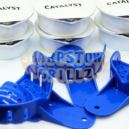 Blue plastic grill grates shown in the foreground with white foil-lidded canisters labeled 'CATALYST' and 'OPEN' in the background. A large semi-transparent 'Sharp Town Grillz' watermark overlays the center.