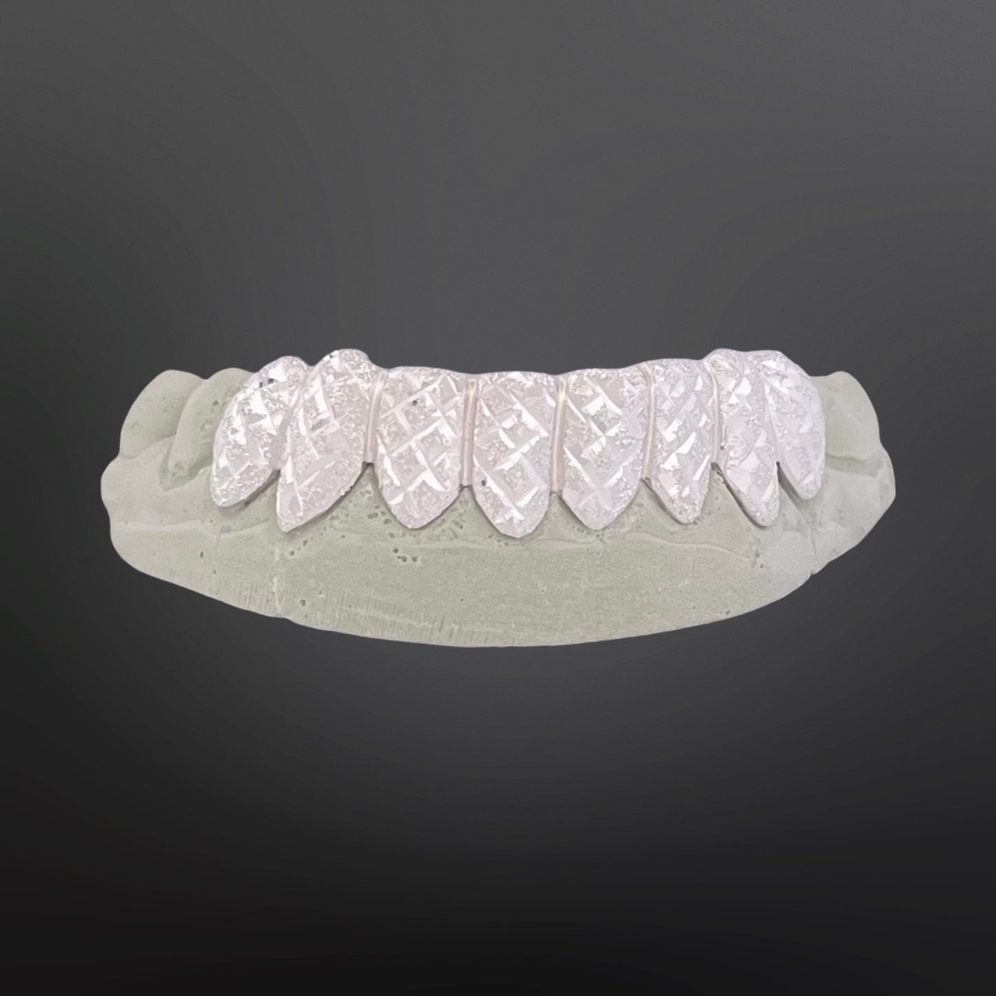 Dental model with white dental implants on a dark gray background