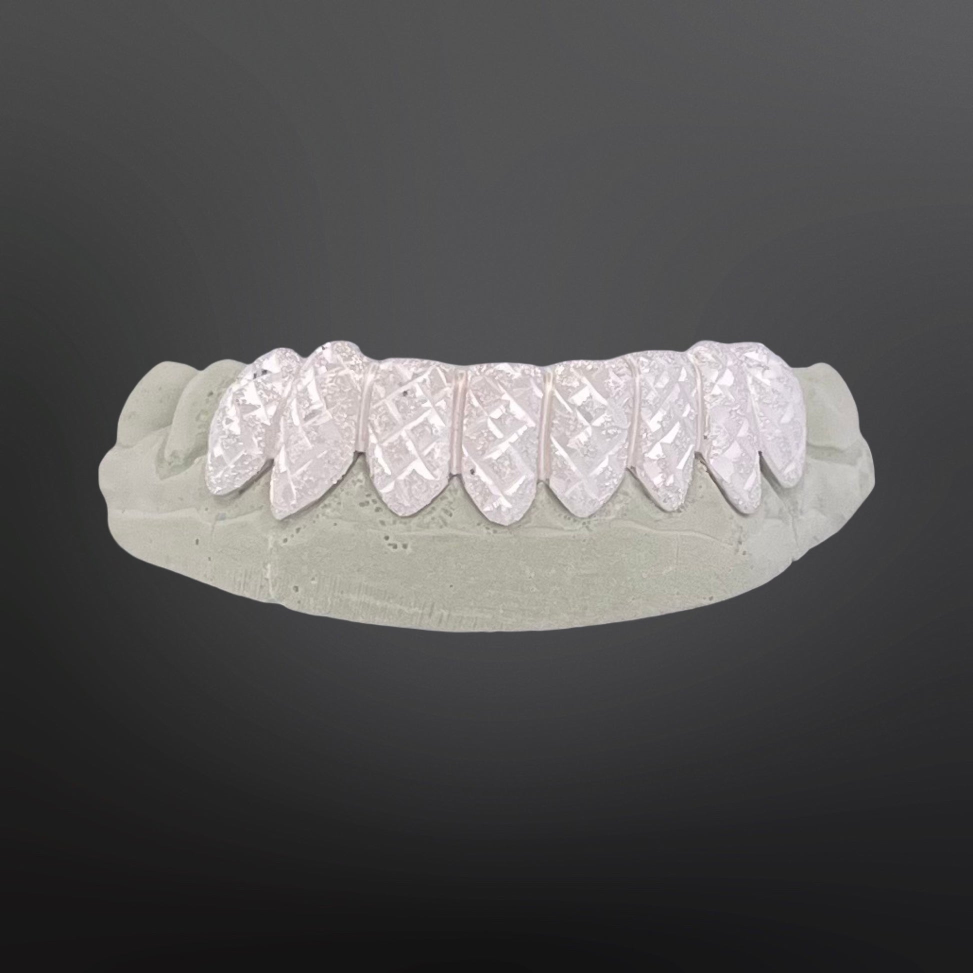 Dental model with white dental implants on a dark gray background
