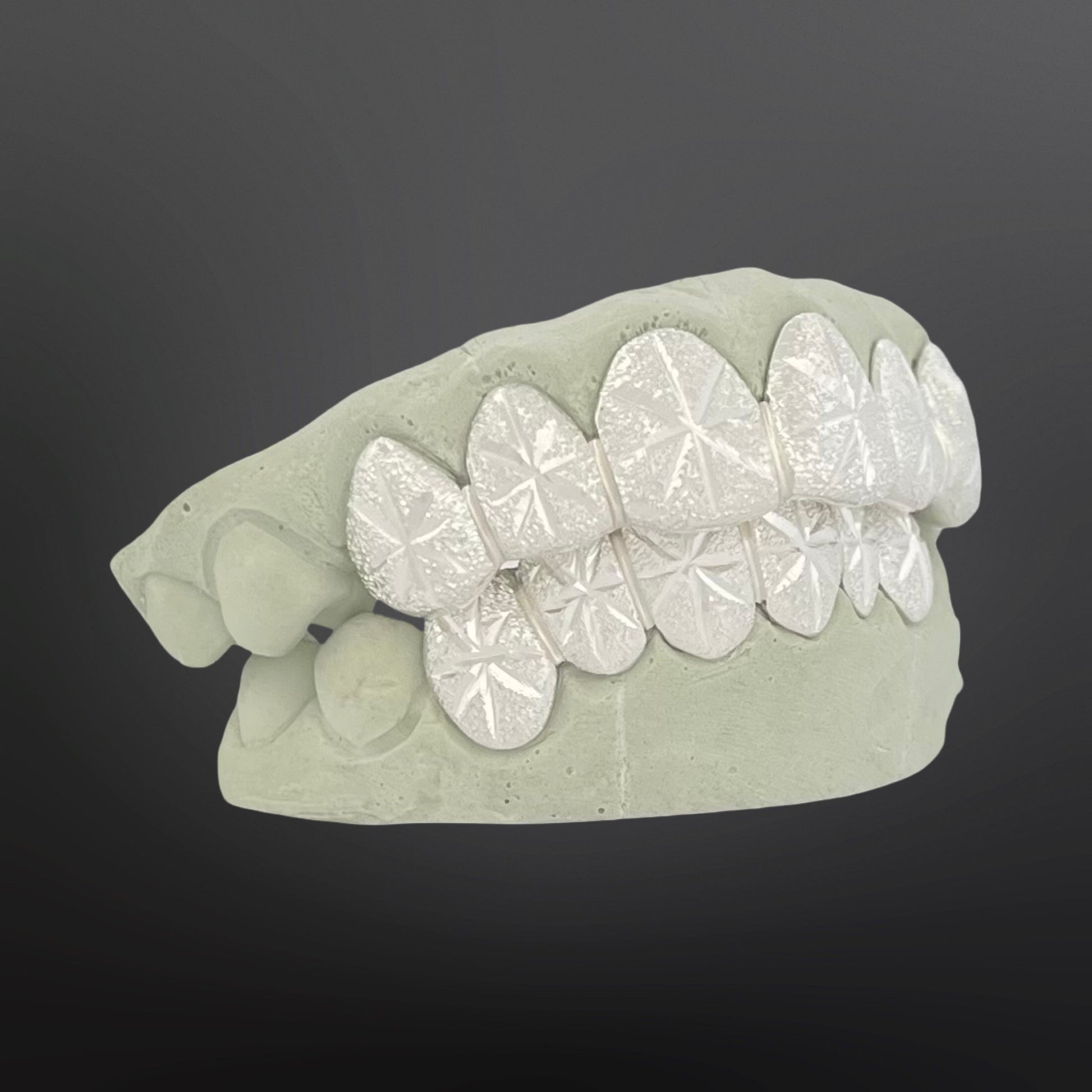 Dental model with white teeth on a dark background