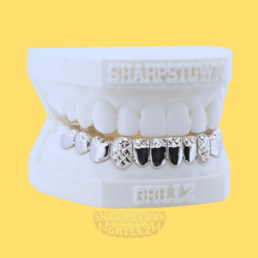 Front view of custom silver lower grillz with black enamel accents and polished silver borders.