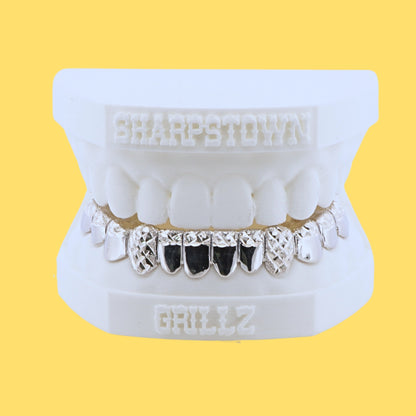 Custom 925 silver bottom teeth caps with black enamel inlay and diamond dust cut outer teeth.