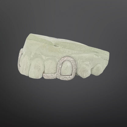 Decorative stone with a central circular design on a dark background