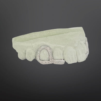 Light green headband with a decorative clasp on a dark gray background