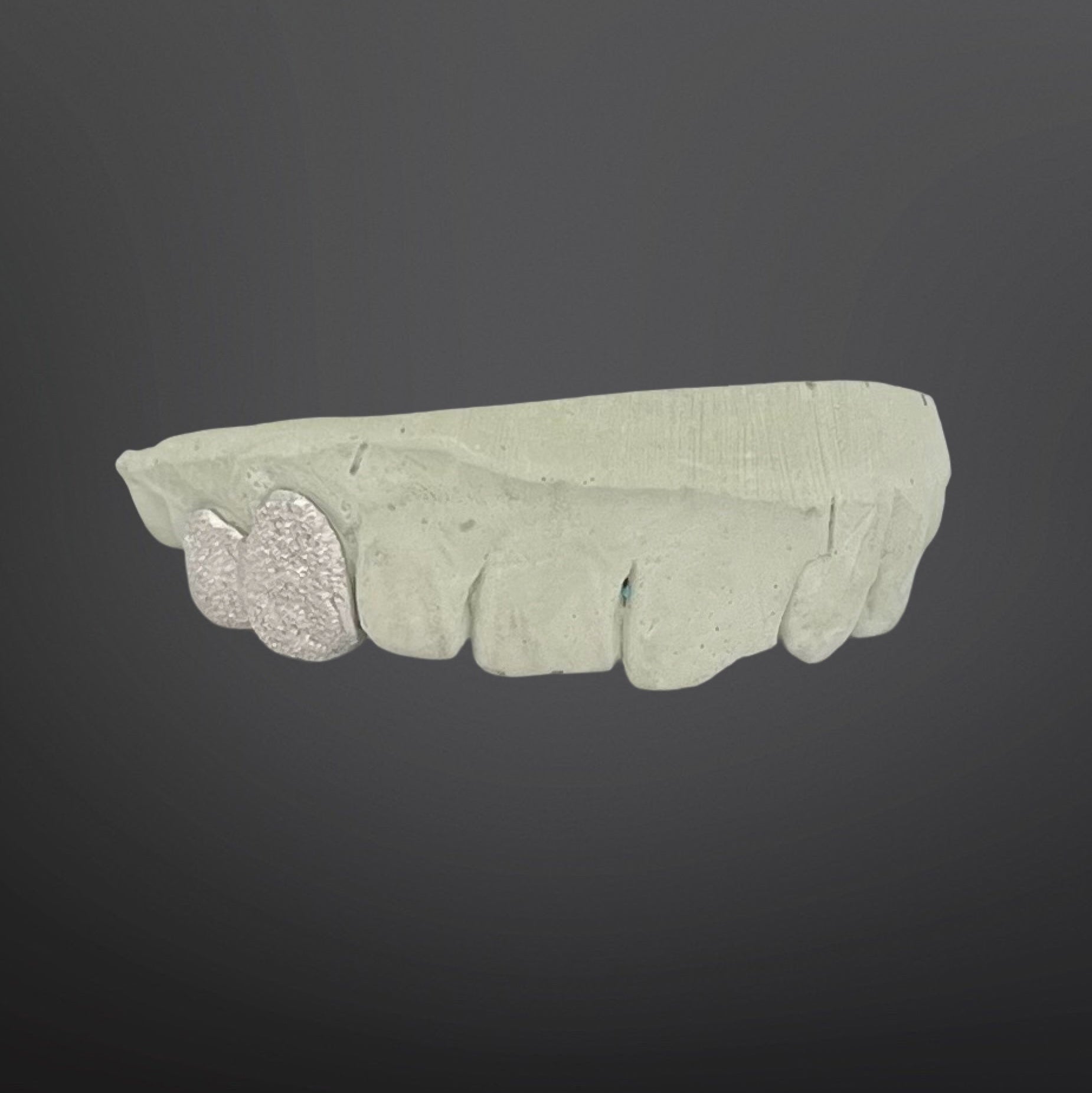Decorative stone with a leaf design on a dark background