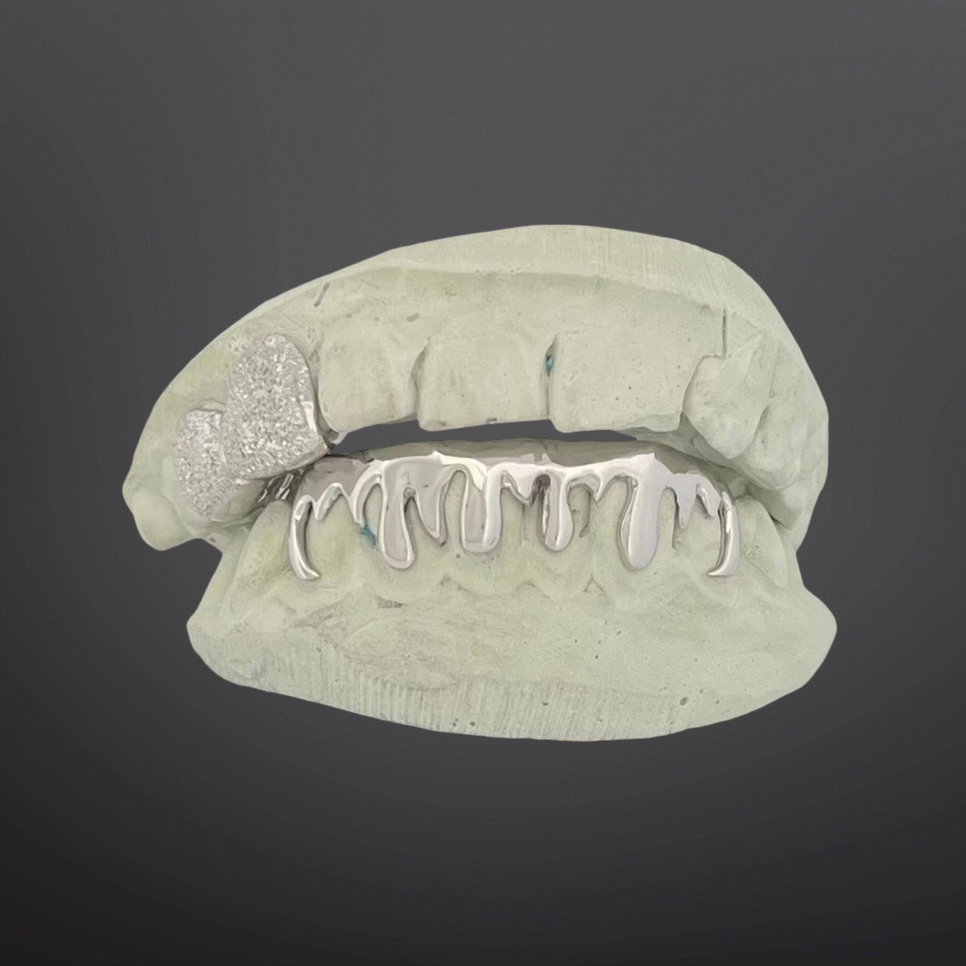 Lip-shaped jewelry with glittery lip gloss on a dark background
