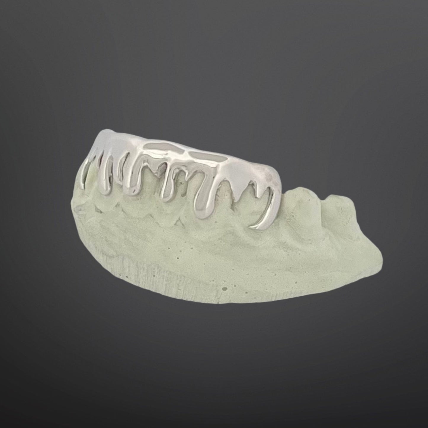 Dental model with metal grill on a dark background