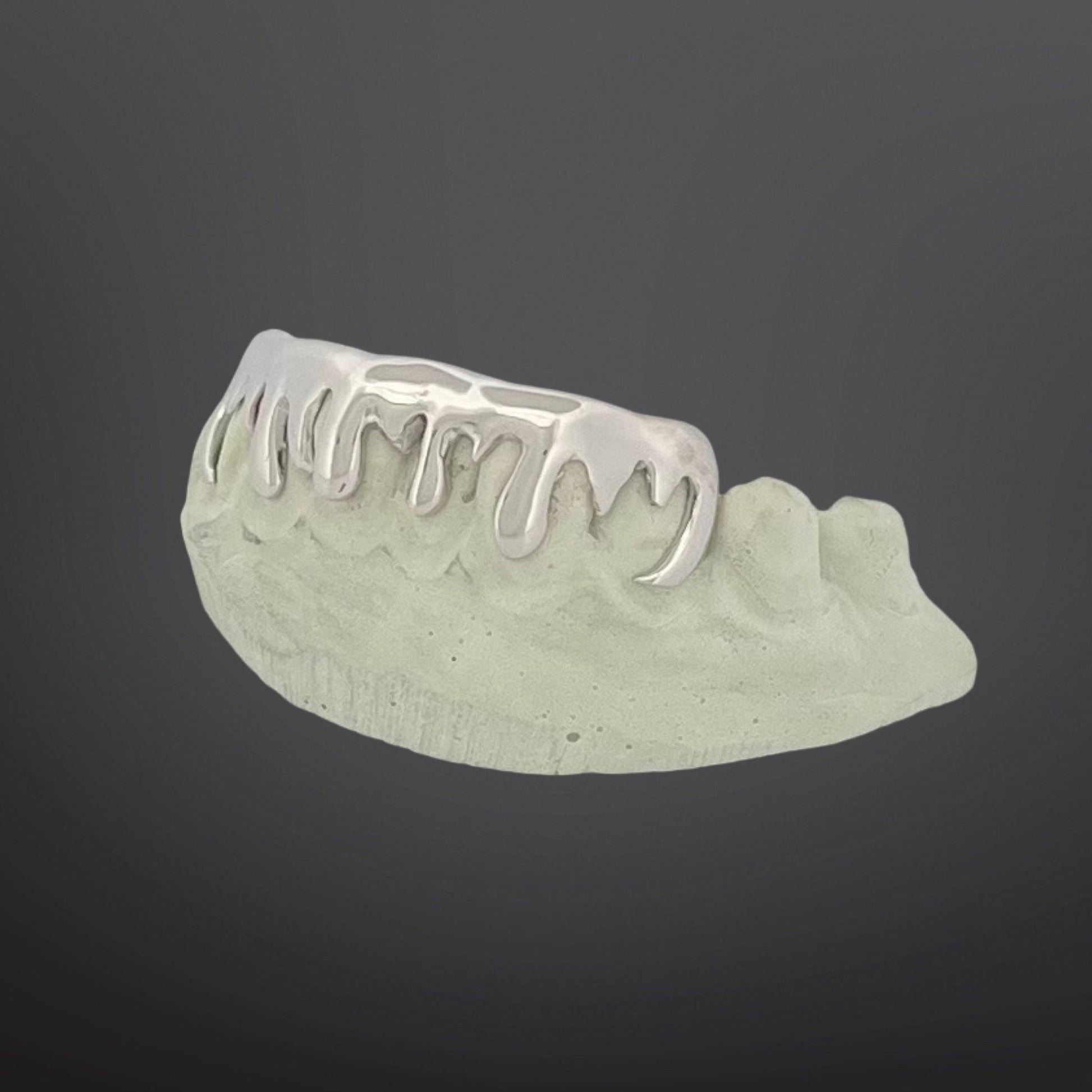 Dental model with metal grill on a dark background