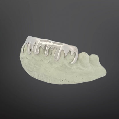 Dental model with metal grill on a dark background