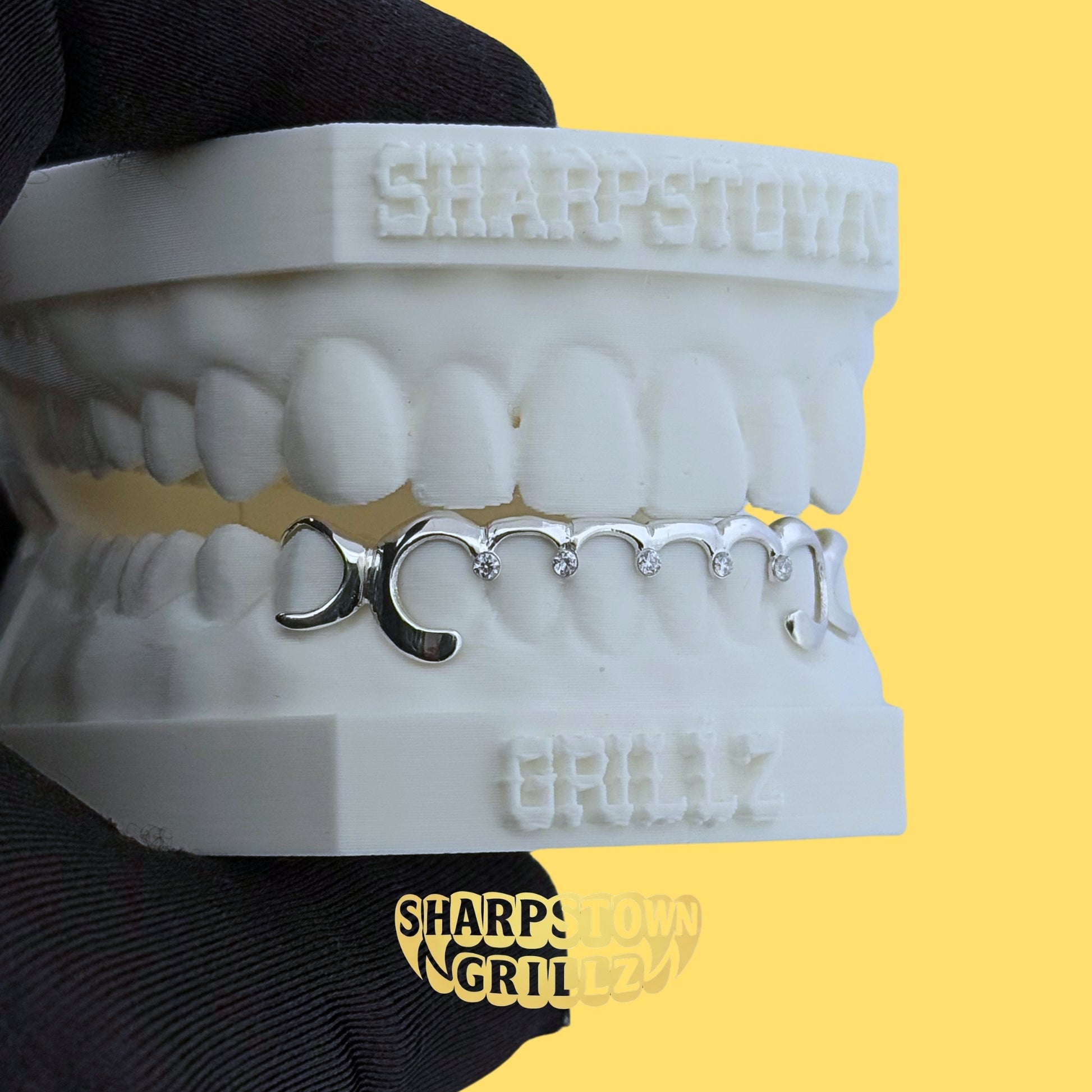 Custom-made upper diamond cut diamond dust teeth grillz available in Silver 925 and 10K Gold.