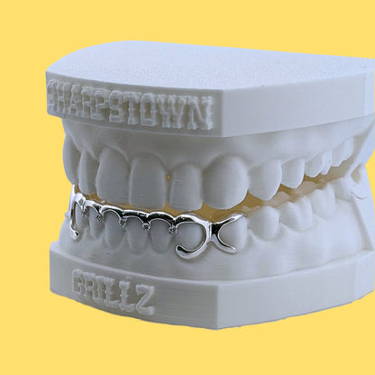 Upper 8 teeth custom diamond cut diamond dust grillz fitted on a 3D dental model with yellow background.