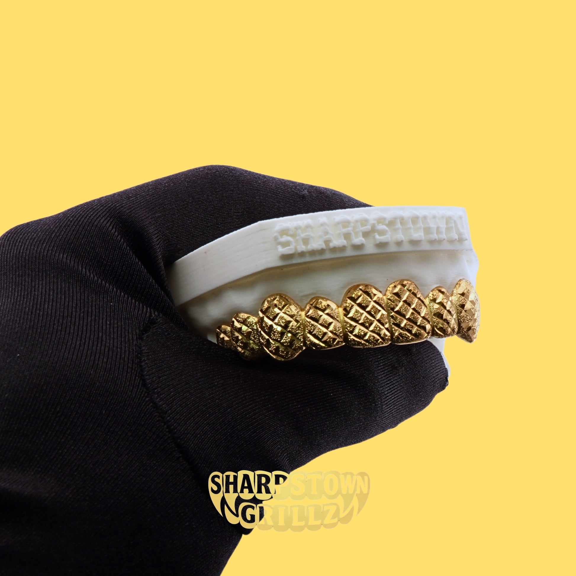 Upper 8 teeth custom diamond cut diamond dust grillz fitted on a 3D dental model with yellow background.