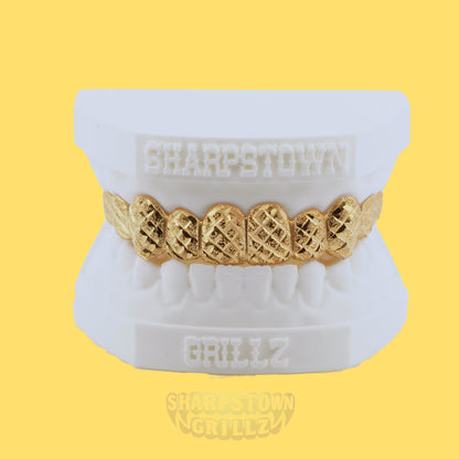 Custom 10K Gold diamond cut top teeth caps with diamond dust textured faces.