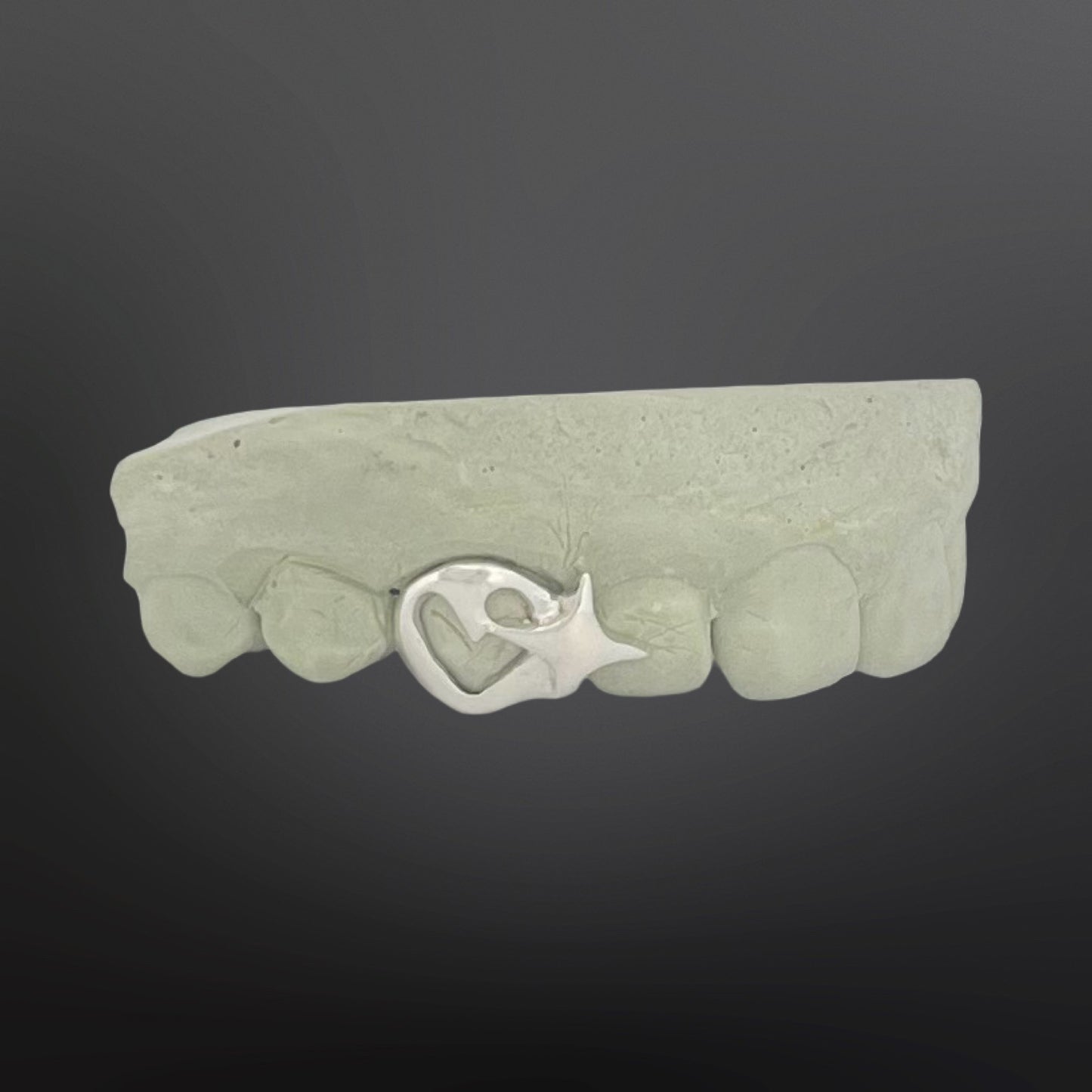 Green stone bracelet with a silver clasp on a dark background