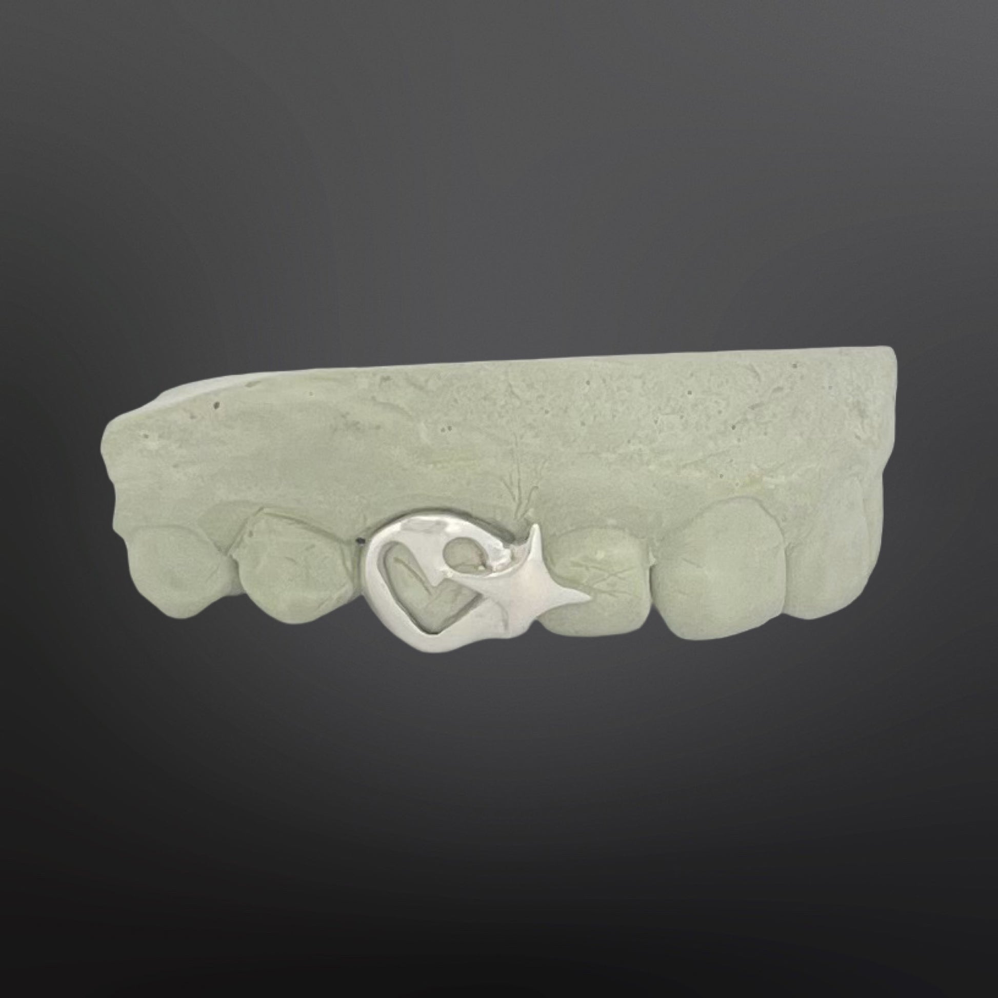 Green stone bracelet with a silver clasp on a dark background