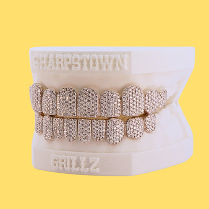 Full mouth iced-out custom teeth caps in Silver 925 with micro pave setting.