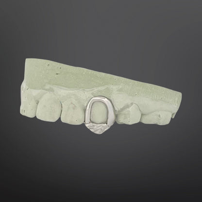 Green stone-like belt buckle with a silver buckle on a dark gray background