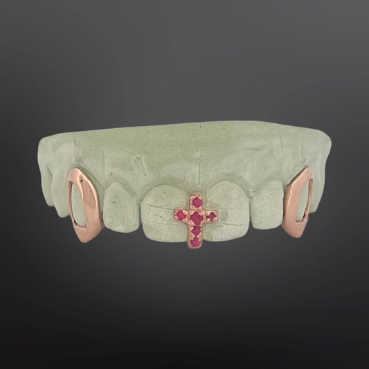 Teeth grill with cross and gemstones on a dark background