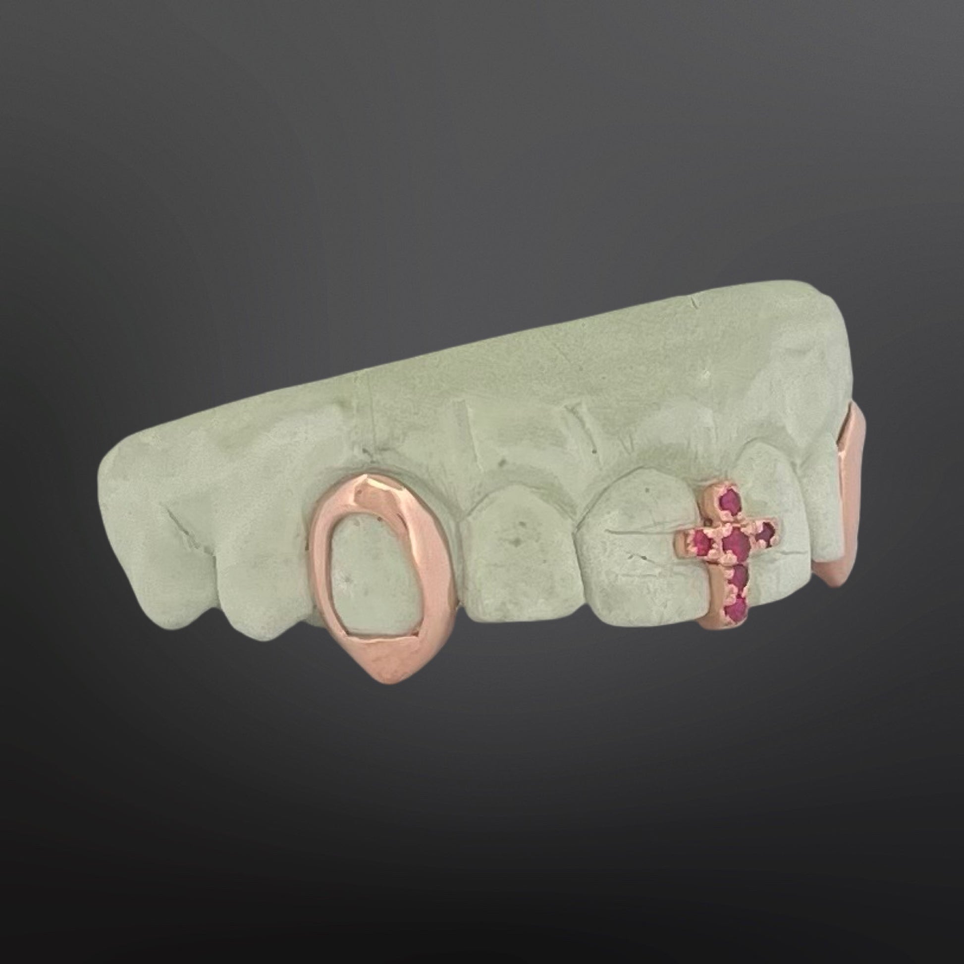 Decorative lip ring with gemstone accents on a dark background