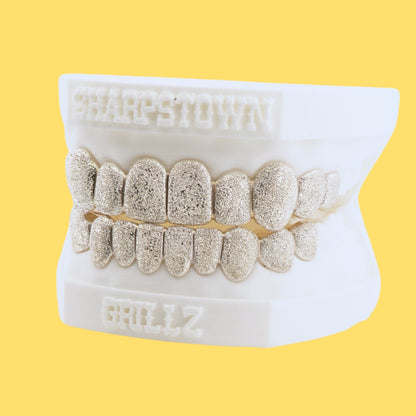 Full coverage diamond dust texture custom grill set in Silver 925 on yellow background.