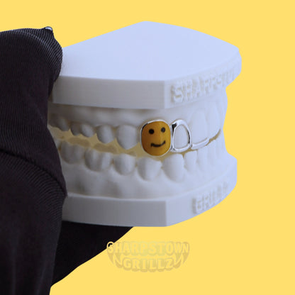 Custom 925 silver smiley face tooth grill with open window frame on upper jaw teeth impression.