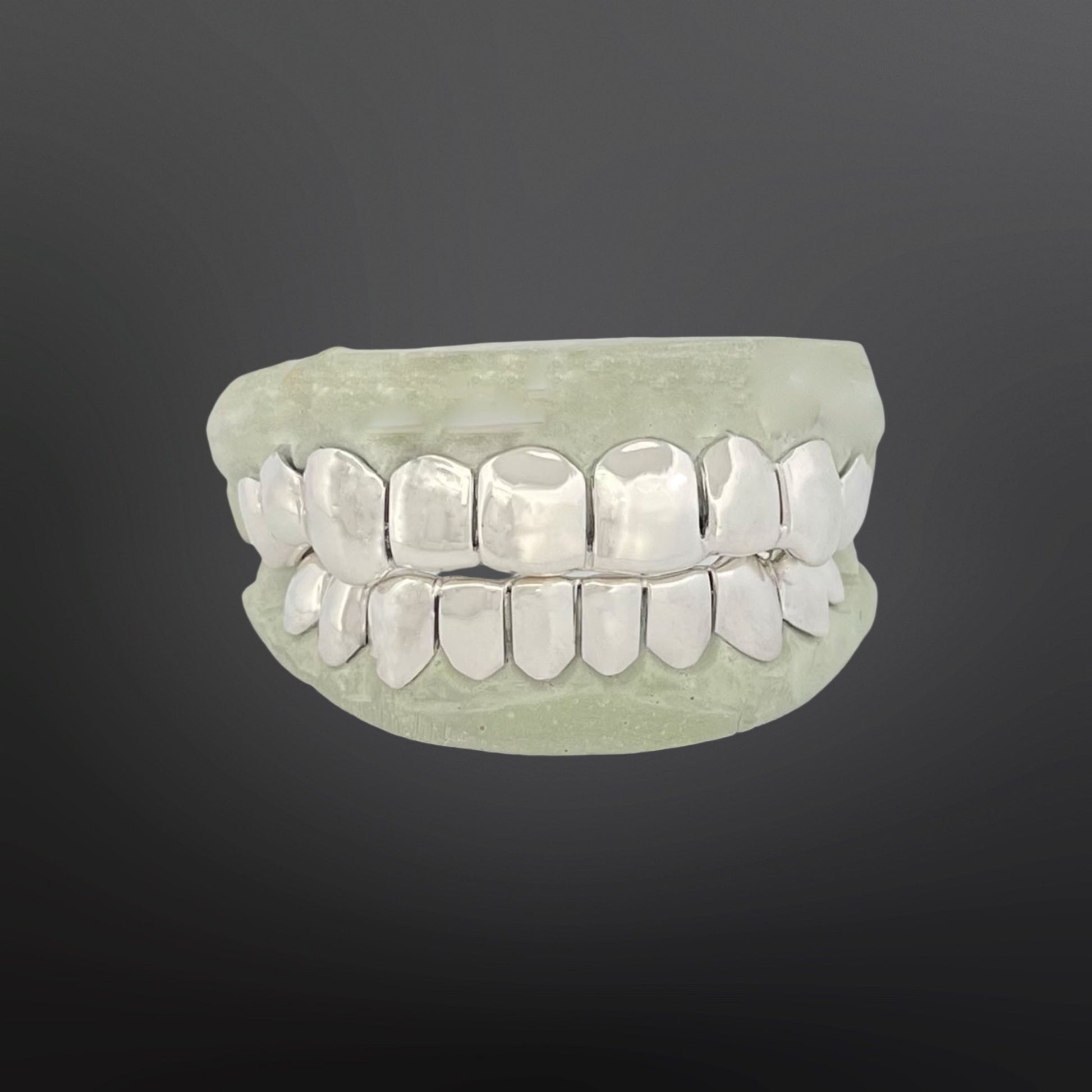 Top and bottom custom plain solid grillz in shiny Silver 925 set on a dental cast model.