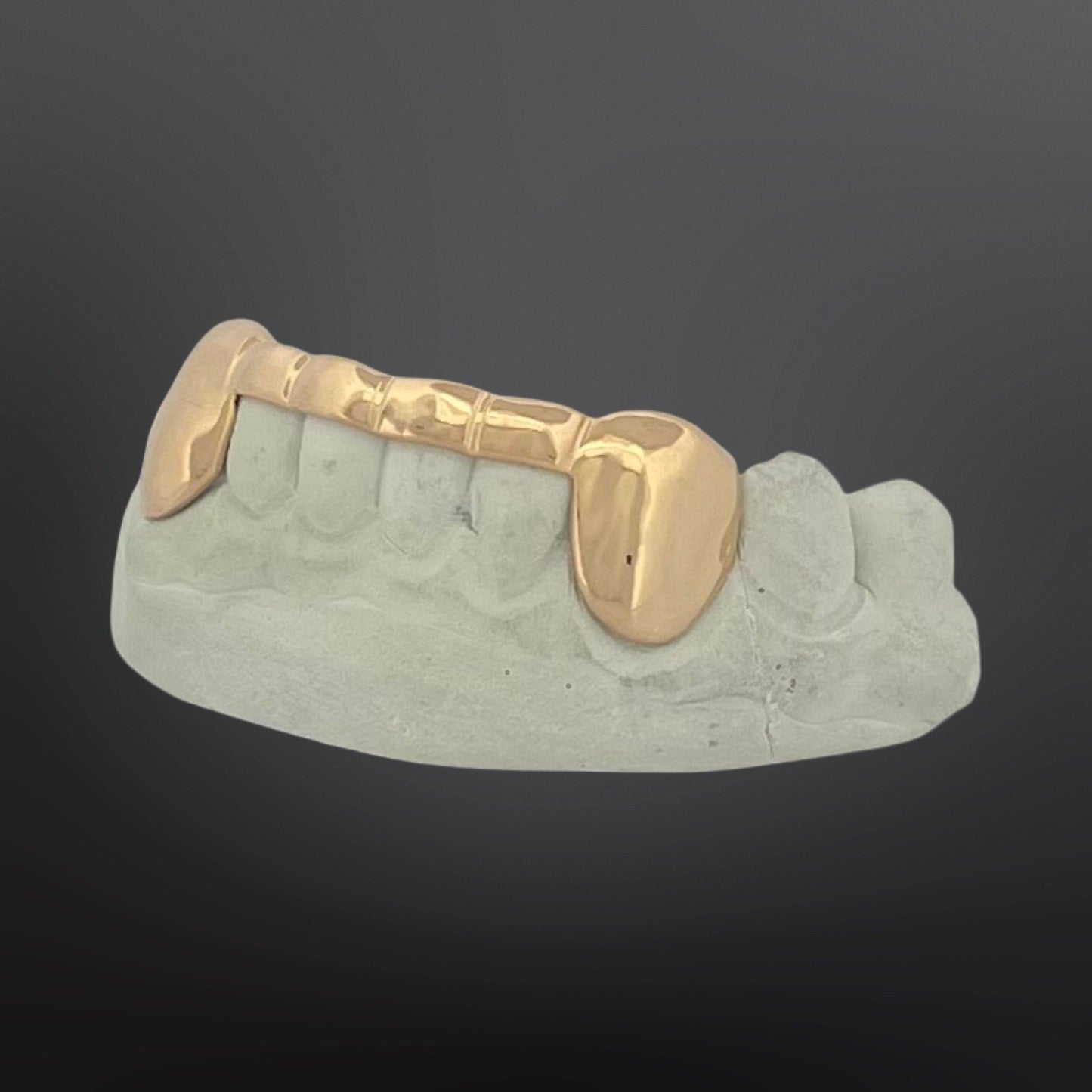 Gold grill on a gray background
