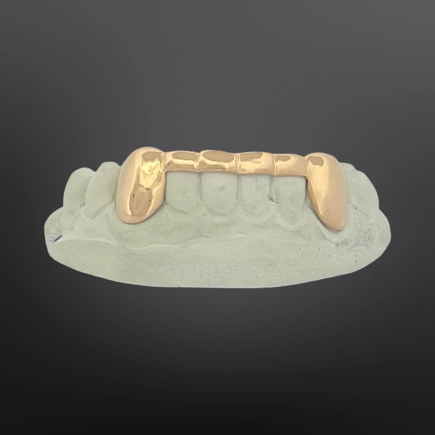 Gold grill on a gray background