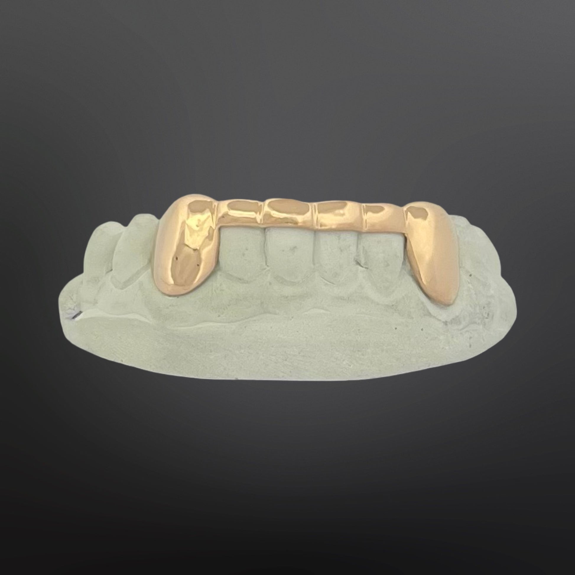 Gold grill on a gray background
