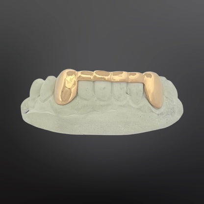 Gold grill on a gray background
