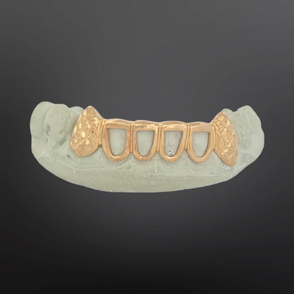 Gold dental grill on a gray background
