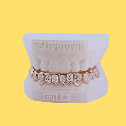 Micro-pave cubic zirconia stone set top and bottom custom grillz on dental model.